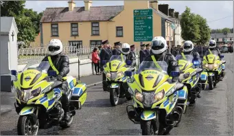  ??  ?? Motorcycle Gardaí arrive at St James’ Church ahead of the coffin of Detective Garda Horkan.