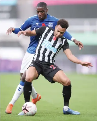  ?? AP ?? Newcastle’s Jacob Murphy, front, and Everton’s Niels Nkounkou during their match on Sunday.