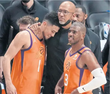  ?? USA TODAY SPORTS ?? Suns head coach Monty Williams, centre, celebrates a win with Devin Booker, left, and Chris Paul.