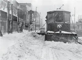  ?? CHICAGO TRIBUNE HISTORICAL PHOTO ?? A streetcar equipped with a snowplow clears the 3700 block of Broadway in Chicago at the end of January 1939.