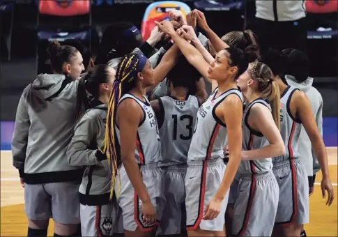  ?? Eric Gay / Associated Press ?? UConn players huddle before their Final Four game against Arizona on Friday at the Alamodome in San Antonio.