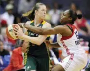  ?? NICK WASS — THE ASSOCIATED PRESS FILE ?? In this file photo, Seattle Storm’s Katie Smith, left, looks for an outlet against Washington Mystics’ Karima Christmas (13) during the second half of an WNBA basketball game in Washington. Smith is among the 13-member class that will be inducted into...