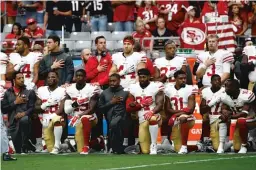  ??  ?? San Francisco 49ers players stand and kneel during the national anthem prior to a game against the Arizona Cardinals on Oct. 1.
| ROSS D. FRANKLIN/ AP