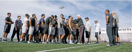  ?? MATT DAHLSEID/THE NEW MEXICAN ?? Capital High football players and coaches meet at the center of the field to end practice Wednesday.