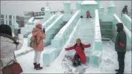  ??  ?? Tourists enjoy a day out at the ice and snow festival in Shenyang.