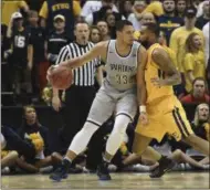  ?? KATHY KMONICEK — THE ASSOCIATED PRESS ?? UNC Greensboro’s center R.J. White (33) drives the ball against East Tennessee State’s forward Isaac Banks (10) during the Southern Conference championsh­ip game.