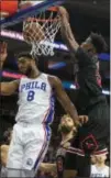  ?? CHRIS SZAGOLA — ASSOCIATED PRESS ?? Chicago Bulls’ Jimmy Butler, right, dunks on the 76ers’ Jahlil Okafor, left, during the first half Friday in Philadelph­ia.