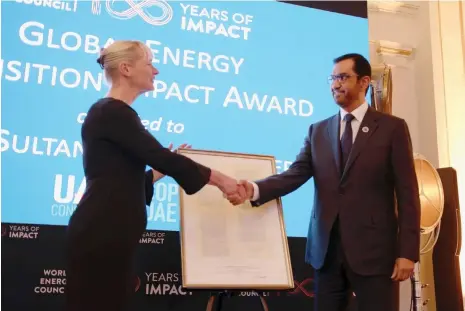  ?? Cop28 ?? Dr Sultan Al Jaber receives the award from the World Energy Council secretary general and chief executive Angela Wilkinson