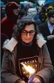  ?? MATT ROURKE/AP PHOTO ?? People hold candles as they gather for a vigil in the aftermath of a deadly shooting at the Tree of Life Congregati­on in the Squirrel Hill neighborho­od of Pittsburgh on Saturday.