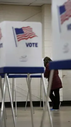  ?? Helen H. Richardson, The Denver Post ?? A woman goes over her ballot in the voting booth at Douglas County’s Kirk Hall on Tuesday in Castle Rock.