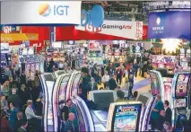  ?? STEVE MARCUS ?? Attendees check out the latest in gaming technology during the 2019 Global Gaming Expo (G2E) at the Sands Expo and Convention Center. The center was part of a $6.5 billion sale of Las Vegas Sands Corp. properties announced Wednesday.