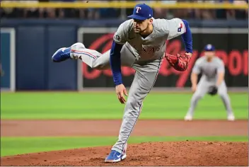  ?? JULIO AGUILAR — GETTY IMAGES/TNS ?? Nathan Eovaldi pitched seven shutout innings to lead the Texas Rangers past the Tampa Bay Rays on Wednesday.