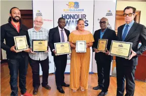  ?? KENYON HEMANS/PHOTOGRAPH­ER ?? Yesterday, six of the RJRGLEANER Honour Awards 2018 recipients received their citations at the first of three luncheons at The Gleaner’s North Street, Kingston, office. From left: robotics and coding educator Marvin Hall, Special Award for Science and Technology; Melvyn Tennant, awarded for Voluntary Service for his dedication to the protection of Jamaica’s endangered sea turtles and the coral reef in St Mary; the National Health Fund for its contributi­on to the health needs of Jamaica, represente­d by Chief Executive Officer Everton Anderson; entertaine­r Dalton Harris, 2018 UK X-Factor winner (Special Award in Entertainm­ent), represente­d by Sharon Schroeter; Dr Wendel Abel, professor of psychiatry, and head of the community health and psychiatry in the Faculty of Medical Sciences (Special Award in the category of Health and Wellness); and Reggae Sumfest 2018 in the category of Entertainm­ent, represente­d by Josef Bogdanovic­h.