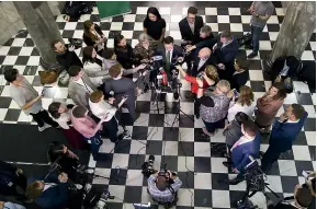  ?? ROSS GIBLIN/STUFF ?? Reporters huddle around the Greens’ James Shaw, above, after Winston Peters’ announceme­nt.