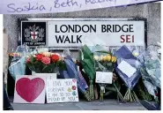  ??  ?? TRAGIC LOSS: Floral tributes and a note left at London Bridge as friends mourn Jack and Saskia during the vigil at Guildhall Yard