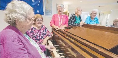  ?? RAISED VOICES: Carinity Fairfield Grange resident Thelma Kilcullen, 83, on the keys with volunteer pianist Bev Haack and friend of Carinity Lorna Mead sing up a tune with residents Enid Abel, 88, and Noreen Thompson, 91. ??