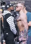  ?? AP FILE PHOTO ?? Floyd Mayweather Jr., left, and Conor McGregor face each other for photos July 13 during a news conference in New York. McGregor’s improbable challenge of Mayweather on Saturday could be seen by a staggering 50 million people in the United States as...