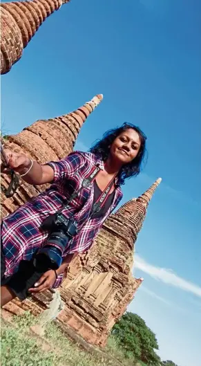  ?? — KALAIVAANI P. SILVARAJAH ?? No one to take your photo when you’re travelling alone? Not a problem as long as there’s a selfie stick, as shown by solo traveller Kalaivaani at one of the temples in Bagan, Myanmar.