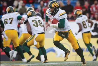  ?? CP PHOTO TODD KOROL ?? Edmonton Eskimos' quarterbac­k Mike Reilly runs the ball during first quarter CFL West Final football action against the Calgary Stampeders in Calgary, Sunday.