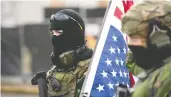  ?? MATHIEU LEWIS-ROLLAND / AFP VIA GETTY IMAGES ?? Members of the Boogaloo Boys stand armed in front of the Oregon State Capitol building in Salem on Sunday at a nationwide protest called by anti-government and far-right groups supporting Donald Trump.