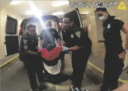  ?? NEW HAVEN POLICE VIA AP ?? In this image taken from police body camera video provided by New Haven Police, Richard “Randy” Cox (center) is pulled from the back of a police van and placed in a wheelchair after being detained by New Haven Police on June 19 in New Haven, Conn.