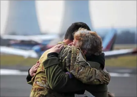  ?? MARIAN DENNIS – DIGITAL FIRST MEDIA ?? Chad Carvalho, an Army maintenanc­e test pilot for Black Hawk helicopter­s, greeted his mother, Donna Knapper, with a hug Jan. 10 as he arrived at Heritage Field Airport in Limerick for a refueling and maintenanc­e stop. Carvalho was tasked with flying a...