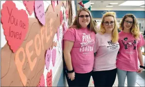  ?? NEWS PHOTO EMMA BENNETT ?? Student council members Camryn Riley (Gr. 11), Rachel Walcer (Gr. 12) and Kristie Newman (Gr. 11) decorate the cafeteria at Crescent Heights High School with anti-bullying messages.