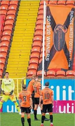  ??  ?? United players watch captain Mark Reynolds raise the Championsh­ip flag after last season’s title triumph.