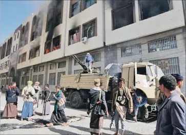  ?? Mohammed Huwais AFP/Getty Images ?? HOUTHI REBELS gather outside the Sana residence of former President Ali Abdullah Saleh, who ruled Yemen for more than 30 years and then tried to topple his successor after being swept from office in 2012.