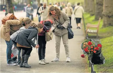  ?? Picture: GETTY IMAGES ?? SAD MOMENT: Members of the public view floral tributes left on Birdcage Walk for Claire Squires, who died while competing in the London Marathon on April 24 in London. Squires, 30, collapsed with less than one mile to run in the marathon