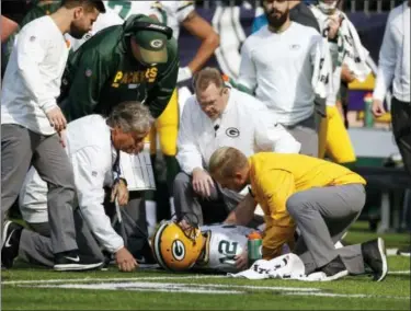  ?? BRUCE KLUCKHOHN — ASSOCIATED PRESS ?? Packers quarterbac­k Aaron Rodgers is attended to by medical staff after being hit by Vikings outside linebacker Anthony Barr in the first half of Sunday’s game at Minneapoli­s.