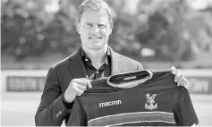  ??  ?? Frank de Boer poses as he is unveiled as the new manager of Crystal Palace Football Club in London. — AFP photo