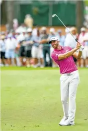  ??  ?? Dustin Johnson hits from the fairway on the first hole during the first round of the Wells Fargo Championsh­ip at Eagle Point Golf Club in Wilmington, N.C., on Thursday.