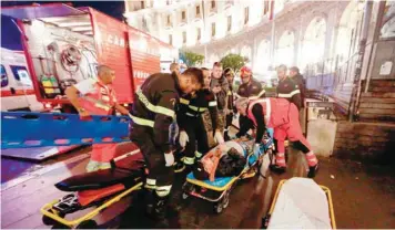  ?? — AFP ?? First responders evacuate a wounded person from Piazza della Repubblica in central Rome when an escalator leading to the Repubblica metro station collapsed.