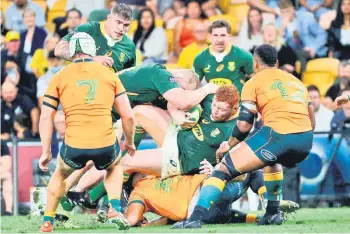  ?? — AFP file photo ?? South Africa’s Steven Kitshoff (centre) is tackled in a ruck during the Championsh­ip match against Australia at the Suncorp Stadium in Brisbane.