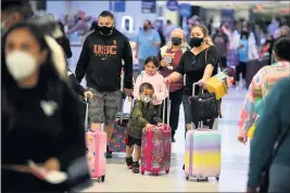  ?? PHOTO BY AXEL KOESTER ?? Travelers check in their luggage at Terminal 7on the eve of what is expected to be a busy Independen­ce Day weekend at LAX on Friday.