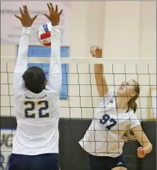  ?? Katharine Lotze/The Signal (See additional photos on signalscv.com) ?? (Top) Saugus teammates celebrate a successful point during a volleyball game at West Ranch on Thursday. (Above) Saugus’ Caitlin Liebe (97) goes for a kill but is blocked by West Ranch’s Maxine Osunsanmi (22) during a volleyball game at West Ranch on...