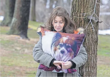  ?? TANYA BREEN/ USA TODAY NETWORK ?? Rhonda Bomwell of Somerset, N. J., lost her 9- year- old Papillon, Pierre, in June because of side effects from wearing a popular flea and tick collar for pets. Regulators have done nothing to inform the public of the risks.