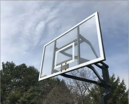  ?? ADAM SCHABEL — THE MORNING JOURNAL ?? The rims were removed from the basketball hoops at Schwartz Road Park in Avon.