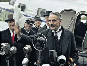  ?? ?? i Spot the difference: Neville Chamberlai­n waves the infamous ‘piece of paper’ on his return from meeting Hitler in 1938, top; above, Jeremy Irons in Netflix’s Munich
h Between the lines: Irons (with Alex Jennings as Sir Horace Wilson) in the film that blends fact and fiction