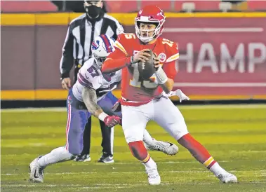  ?? JEFF ROBERSON/ASSOCIATED PRESS ?? Chiefs quarterbac­k Patrick Mahomes scrambles up field ahead of Buffalo Bills defensive end AJ Epenesa in the AFC championsh­ip Sunday in Kansas City, Mo. Mahomes threw three TDs after spending the week in the NFL concussion protocol.