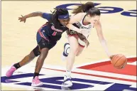  ?? Jessica Hill / Associated Press ?? UConn’s Nika Muhl, right, steals the ball from St. John’s Unique Drake during their Big East Tournament quarterfin­al game Saturday.