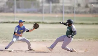  ?? PHOTOS BY LUIS SÁNCHEZ SATURNO/THE NEW MEXICAN ?? Desert Academy’s Pablo Carrazco-Nava, right, slides safely into second base past Peñasco’s Zach Gonzales during the bottom of the first inning.
