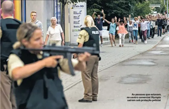  ??  ?? As pessoas que estavam no centro comercial Olympia saíram sob proteção policial