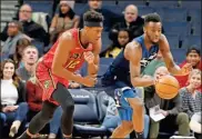  ??  ?? Minnesota Timberwolv­es’ Andrew Wiggins, right, and Atlanta Hawks’ De’Andre Hunter chase the ball in the first half of an NBA basketball game Wednesday, Feb. 5, 2020, in Minneapoli­s.