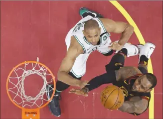  ?? The Associated Press ?? Cleveland Cavaliers’ LeBron James, right, drives to the basket against Boston Celtics’ Al Horford during the second half of Game 6 of the NBA Eastern Conference final on Friday in Cleveland.The Cavs won 109-99.