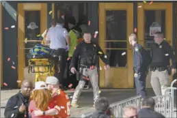  ?? AP photo ?? Emergency personnel take a stretcher into Union Station following a shooting at the Kansas City Chiefs Super Bowl celebratio­n in Kansas City, Mo., on Wednesday. Multiple people were injured, a fire official said.