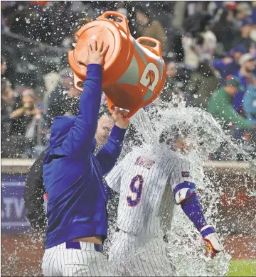  ?? USA Today Sports - Vincent Carchietta ?? Mets left fielder Brandon Nimmo is splashed by teammates after hitting a walk-off two-run home run in Sunday’s game against the Mets at Citi Field in New York.