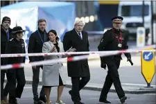  ?? STEVE PARSONS/PA VIA AP ?? Britain’s Prime Minister Boris Johnson, second right, Home Secretary Priti Patel, center, and Metropolit­an Police Commission­er, Cressida Dick, left, attend the scene in central London, Saturday, Nov. 30, after an attack on London Bridge on Friday.