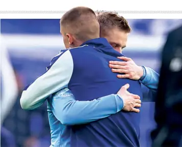  ?? AP ?? Country in turmoil: Manchester City’s Oleksandr Zinchenko of Ukraine, left, and Everton's Vitaliy Mykolenko of Ukraine share an emotional moment prior to the English Premier League match in the wake of Russia's attack on Ukraine.